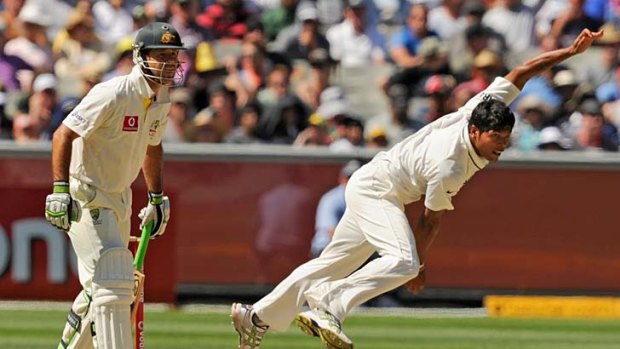 Lean on me: Indian paceman Umesh Yadav lets rip at the MCG yesterday as Ricky Ponting watches on.