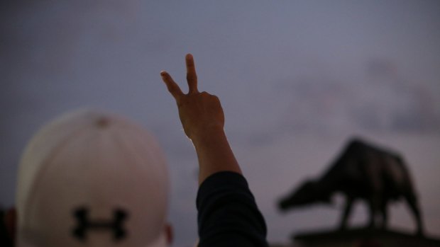 A supporter of Bongbong Marcos makes a "V" for victory sign at protest in Manila on Wednesday.