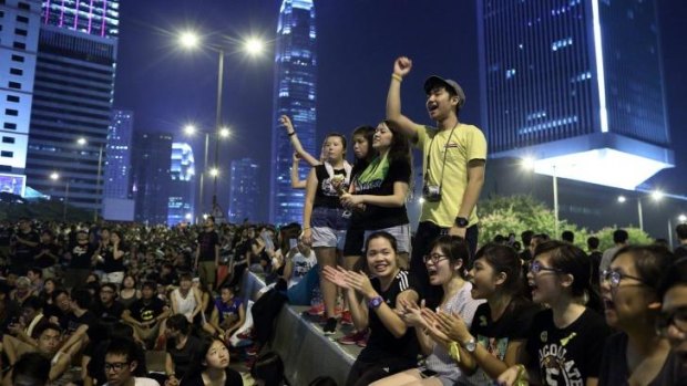 Demonstrators gather during a protest near the central government office at night in Hong Kong. 