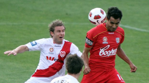 Danger: Marcos Flores (right) playing for Adelaide United.