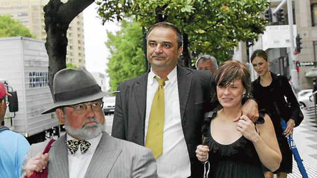 Ali Alkan (right, at centre) leaves court on Friday.