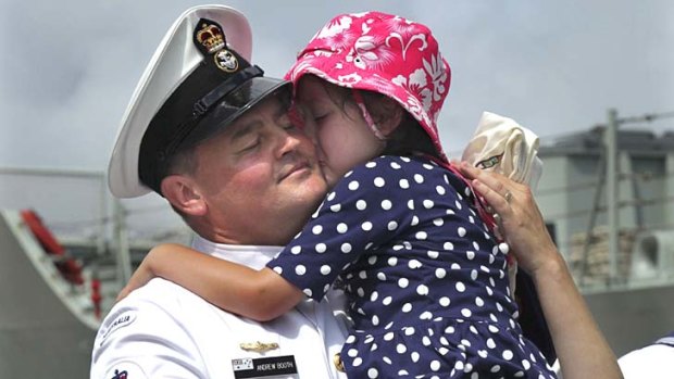 Emotional: Maddie, 5, hugs her father Petty Officer Andrew Booth.