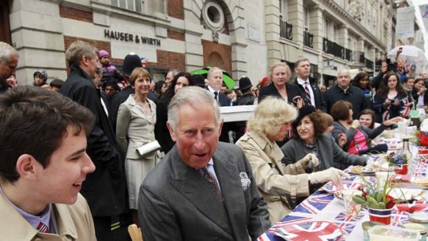 Long to rain over us  ... Prince Charles and his wife Camilla join a London street party on a day when festivities  could not be dampened.