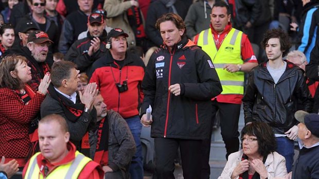 On you, Hirdy: Essendon fans shout encouragement to under-siege coach and playing legend James Hird last Saturday.