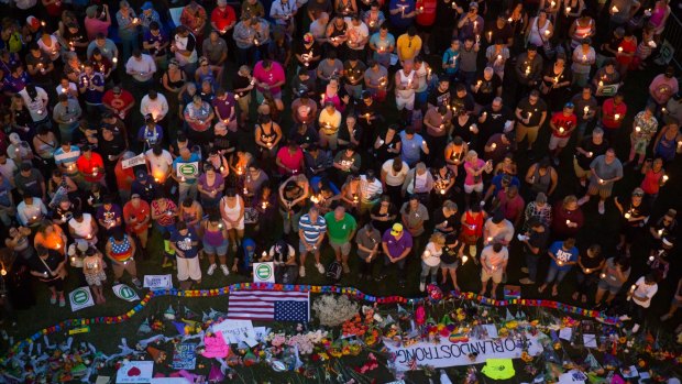Mourners attend a candlelight vigil the day after an attack on a gay nightclub left at least 50 people dead.