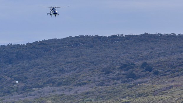 A police helicopter hovers over Anglesea.