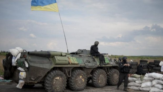 Ukrainian National Guard troops guard a checkpoint outside Slaviansk in eastern Ukraine, where pro-Russian rebels are reportedly surrounded but there has been no direct offensive on the town.