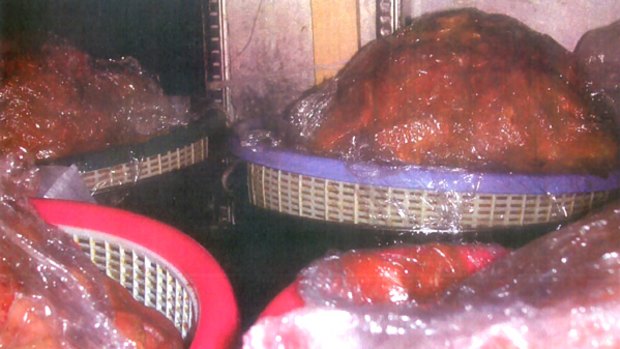 Restaurant closed ... raw beef exposed to potential contamination sits under a refrigerator.