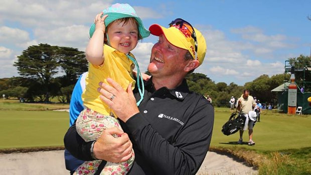 Jarrod Lyle hugs his daughter Lusi after completing round four.