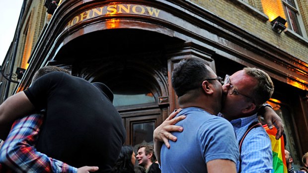 Passionate response ...  couples lock lips in protest outside the John Snow pub in Soho after gay pair Jonathan Williams and James Bull were booted out of the boozer for showing affection towards each other.