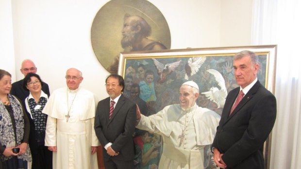 Inspired by forgiveness: Bundeena artist Jiawei Shen, centre, with Pope Francis and Australian Senate president John Hogg.