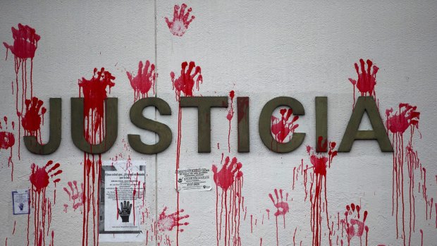 Red handprints cover the word "Justice" on the outside wall of the Supreme Court building during a protest by human rights activists in Guatemala City, last week.