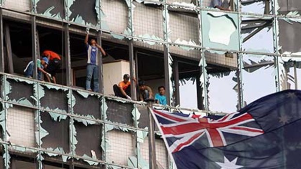 Flashback ... workers remove broken glass from the Australian  embassy in Jakarta after a bombing in 2004.