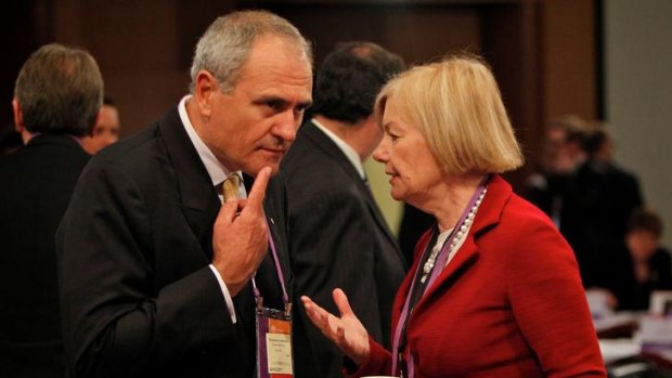 Former Treasury head Ken Henry and the Australian Industry Group's Heather Ridout confer at the tax summit at Parliament House.