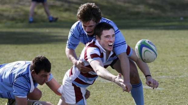 Marist College players James Kazis and Montana O'Neill tackle Hills Sports High School Sydney player Chris Asmus.