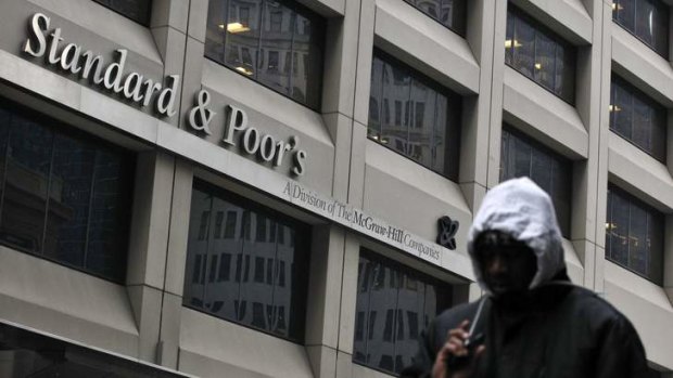 A man walks past the Standard & Poor's building in New York's financial district.