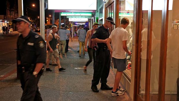 Under close watch ... a boy is questioned by police at schoolies.