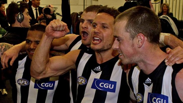 Pie night: Leon Davis, Heath Shaw, Luke Ball and Nick Maxwell sing the Collingwood theme song after the Magpies' dramatic win at the MCG.
