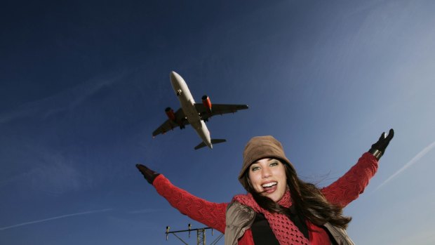 Woman with plane flying overhead.