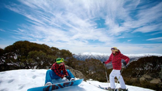 Snowboarder Beau Karolos and skier Samara Tanton enjoy the snow-covered Bogong High Plains at Falls Creek yesterday.
