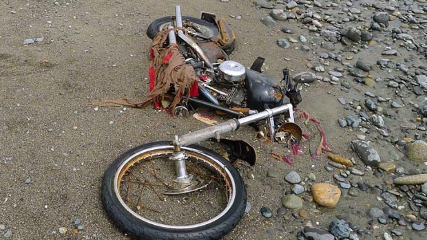 A Harley-Davidson motorbike lost in last year's tsunami lies on a beach in Graham Island, western Canada.
