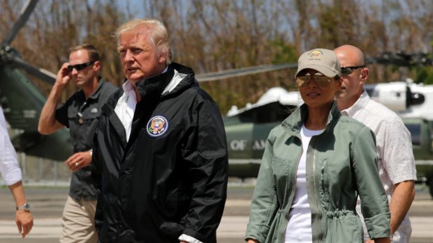 President Donald Trump and first lady Melania Trump walk after arrival in San Juan, Puerto Rico.