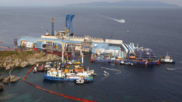 The Costa Concordia ship lies on its side on the Tuscan Island of Giglio, Italy. An international team of engineers is expected to try a never-before attempted strategy to set upright the luxury liner.