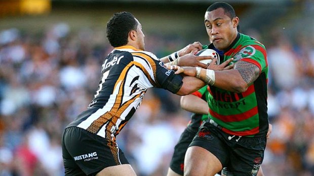 Roy Asotasi of the Rabbitohs takes on Benji Marshall of the Tigers in 2007.