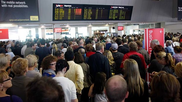 Thousands of passengers return to the Qantas domestic terminal at Melbourne Airport after being evacuated over a security breach.