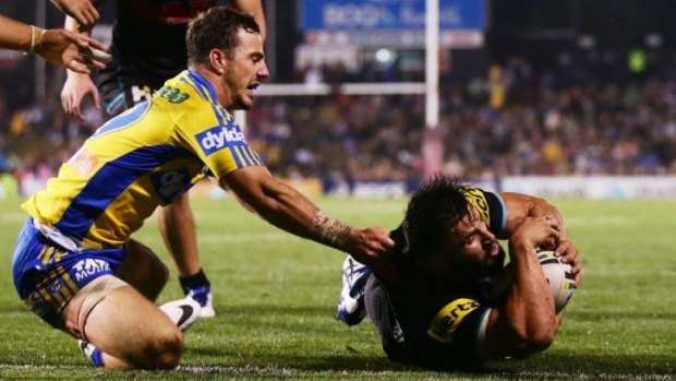 Statistically number one: Panthers winger Josh Mansour crosses for a try against the Eels.