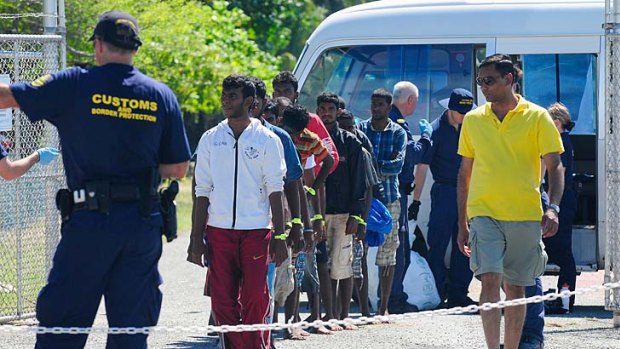 Lined up ... asylum seekers at the Cocos Islands.