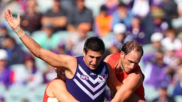 The Dockers' Matthew Pavlich is tackled by the Suns' Gary Ablett and Josh Fraser at Subiaco Oval yesterday.