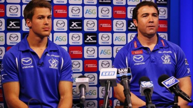 Andrew Swallow and North Melbourne coach Brad Scott speak to the media on Monday.