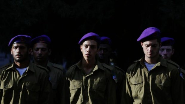 Comrades of Lieutenant Hadar Goldin mourn during his funeral.