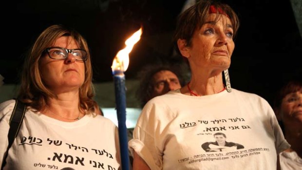 Israeli women wear T-shirts with a portrait of abducted Israeli soldier Gilad Shalit during a rally calling for his release.
