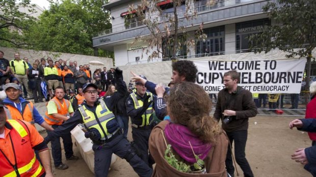 An officer confronts protesters in City Square.