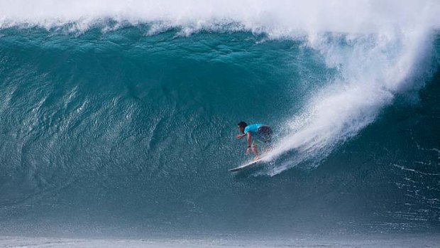 Wall of water: Joel Parkinson tames a wave at Hawaii's Banzai Pipeline.