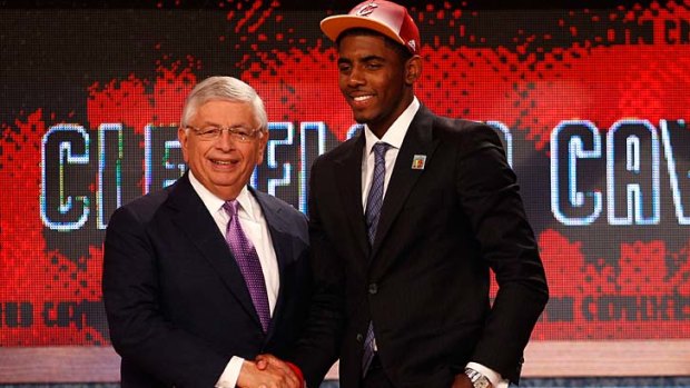 Kyrie Irving (right) greets NBA commissioner David Stern after he was selected number one overall by the Cleveland Cavaliers in the first round during the 2011 US NBA Draft.