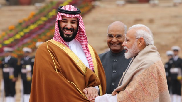 Mohammed Bin Salman, left, is greeted by Indian President Ram Nath Kovind, centre, and Prime Minister Narendra Modi at the presidential palace in Delhi.