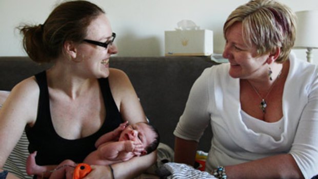 Easy ... Nichola Davenport, 25, with her four-day-old daughter, Sascha, gave birth at home with the help of Sonja Davenport.