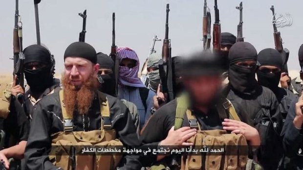 ISIL fighters alongside Georgian native and military leader Abu Omar al-Shishani (red beard).