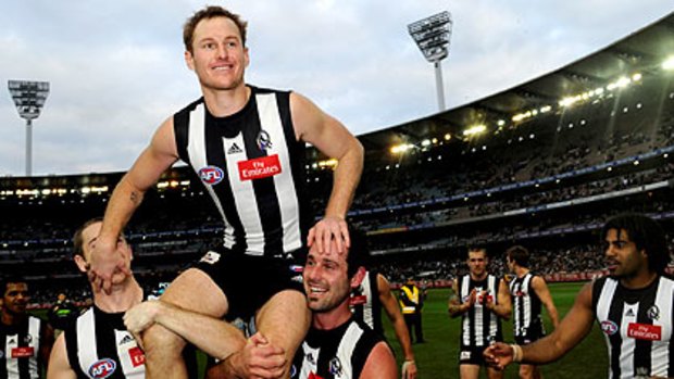 High point: Ben Johnson is chaired off the ground in July after playing his 200th game.