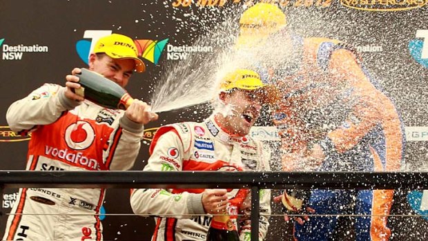 Bubbles galore ... Craig Lowndes, left,  and Jamie Whincup celebrate their one-two finish in the V8 Supercars championship on Sunday.