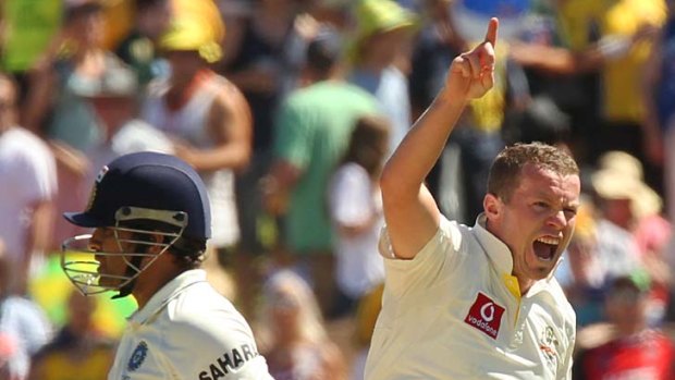 Australian fast bowler Peter Siddle rushes forward after taking the wicket of the great Sachin Tendulkar.