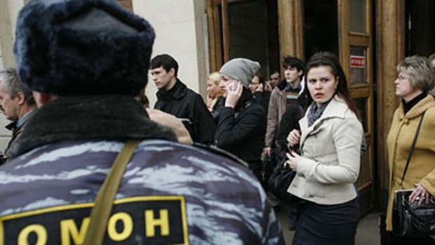 A police officer evacuates people from Park Kultury subway station in downtown Moscow.