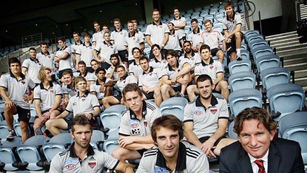 All together now: Jobe Watson (front, centre) and coach James Hird (right) with the 2012 Essendon playing list yesterday.