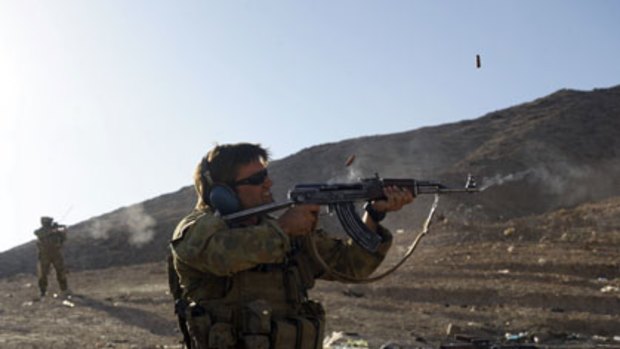 Battleground ... an Australian soldier fires an AK-47 in Oruzgan province.