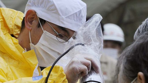 A baby is checked for radiation exposure in Fukushima prefecture