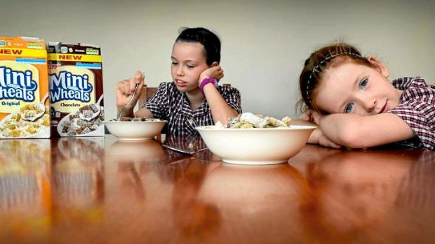 Madison and Emily Adams with the new sugar-laden version of Kellogg's Mini-Wheats.
