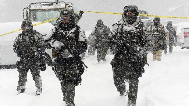 A SWAT team returns to the command post at Bear Mountain near Big Bear Lake, California, after searching for Christopher Jordan Dorner on Friday. Search conditions have been hampered by a heavy winter storm in the area.